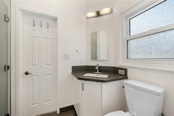 a bathroom with a toilet sink and mirror