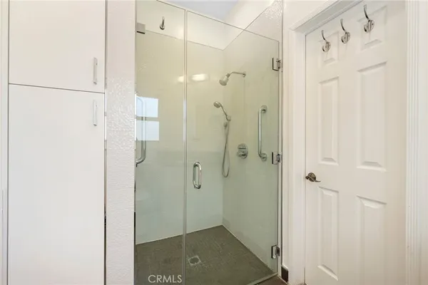 a bathroom with a shower and a glass door