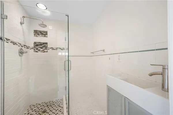 a bathroom with a shower and a sink