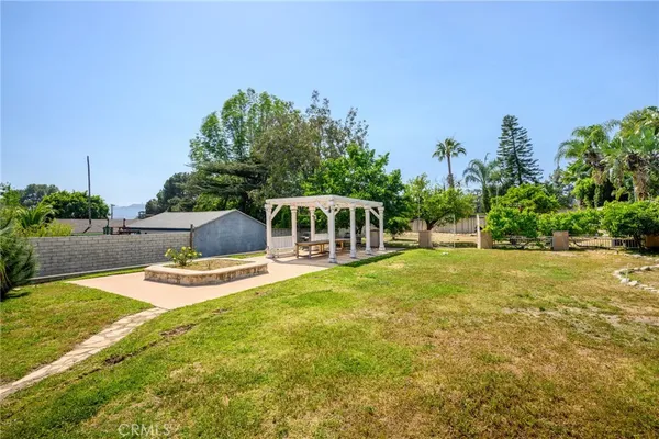 a front view of a house with a yard and trees
