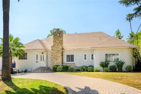 a view of a white house with a swimming pool