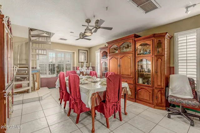 a living room with furniture a chandelier and a large window