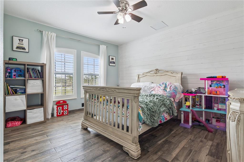 345 Cypress Isles Road Osteen, FL 32764 - Photo 20 of 41 a bedroom with furniture and a book shelf