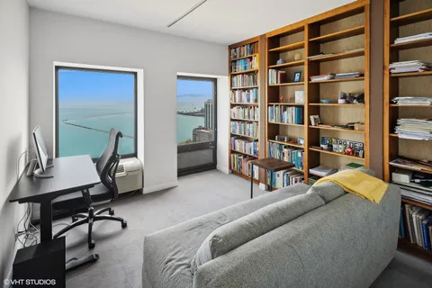 a living room with furniture and a book shelf
