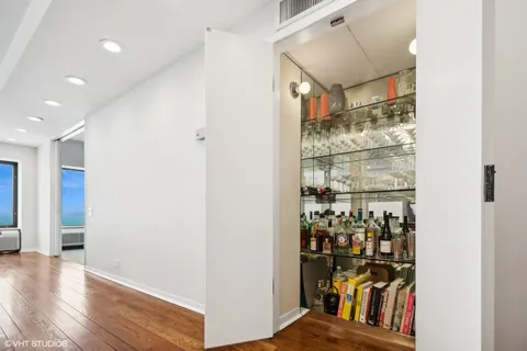 a view of a hallway with wooden floor and dining room