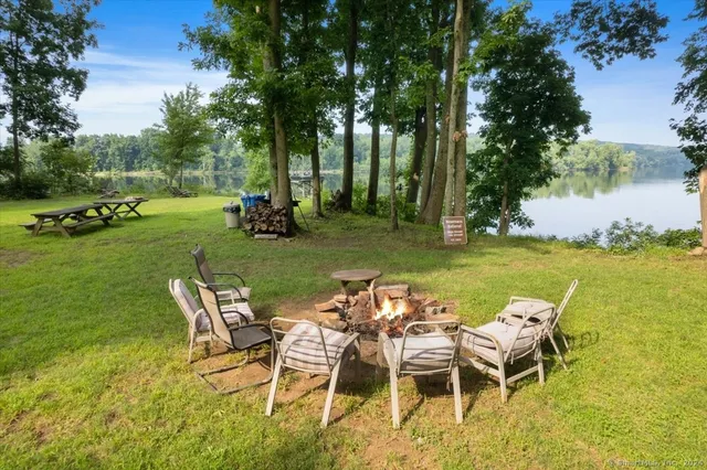 a backyard of a house with table and chairs