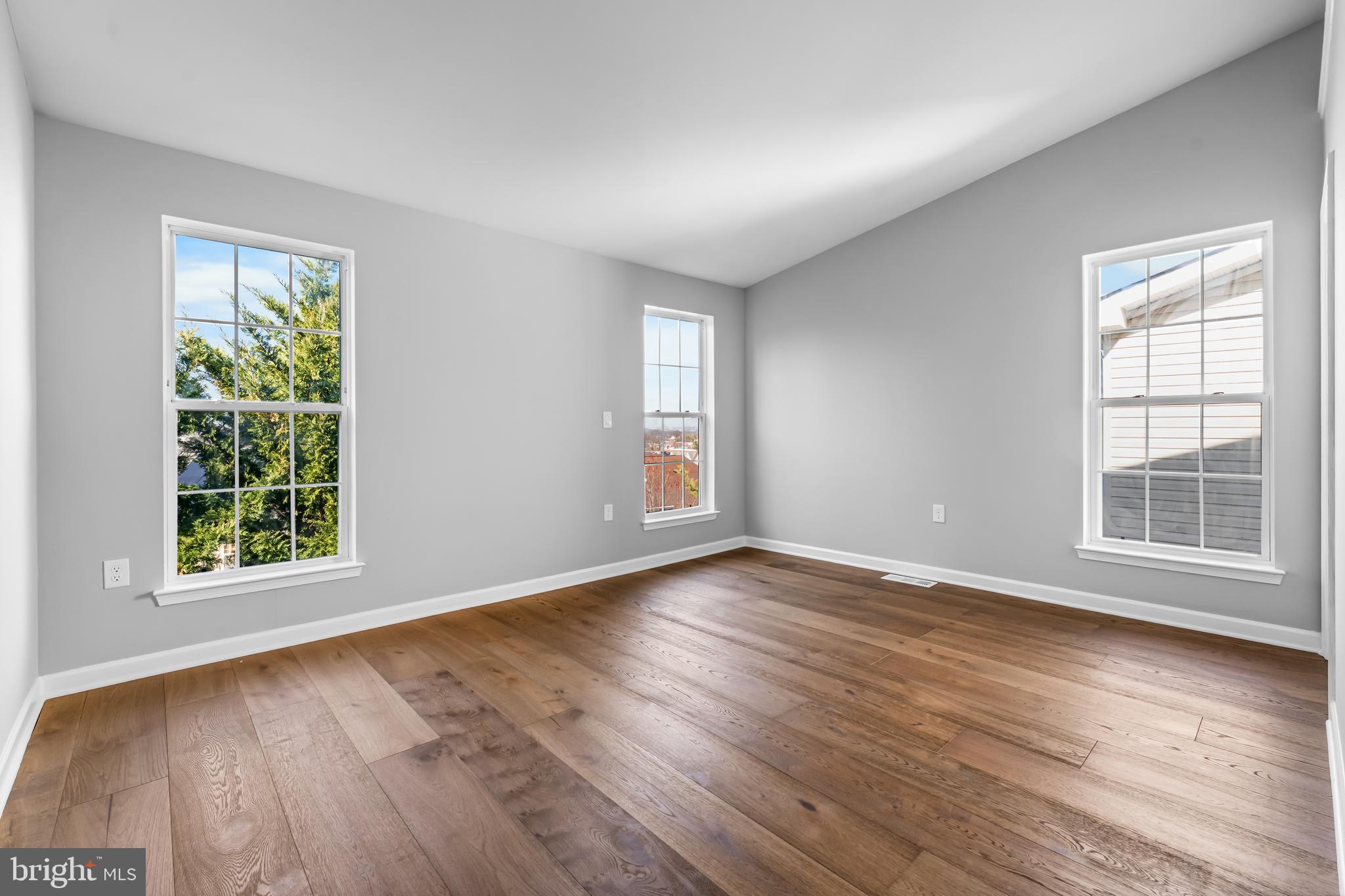 149 58th Street Southeast Washington, DC 20019 - Photo 11 of 32 an empty room with wooden floor and windows