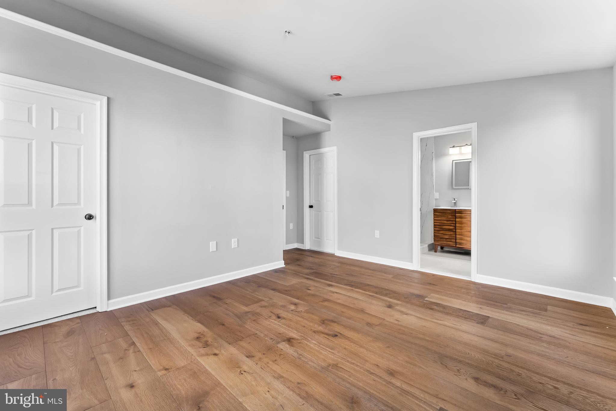 149 58th Street Southeast Washington, DC 20019 - Photo 13 of 32 a view of an empty room with wooden floor and entryway