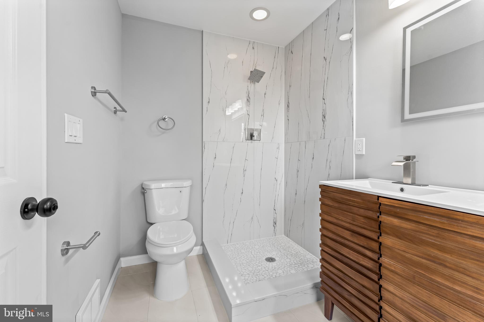 149 58th Street Southeast Washington, DC 20019 - Photo 15 of 32 a bathroom with a sink a toilet and shower