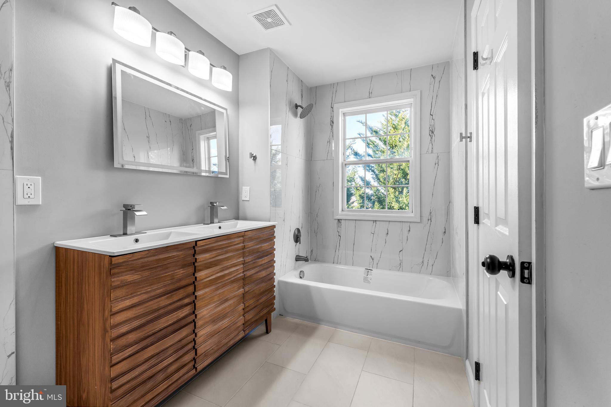 149 58th Street Southeast Washington, DC 20019 - Photo 16 of 32 a bathroom with a tub a sink and mirror
