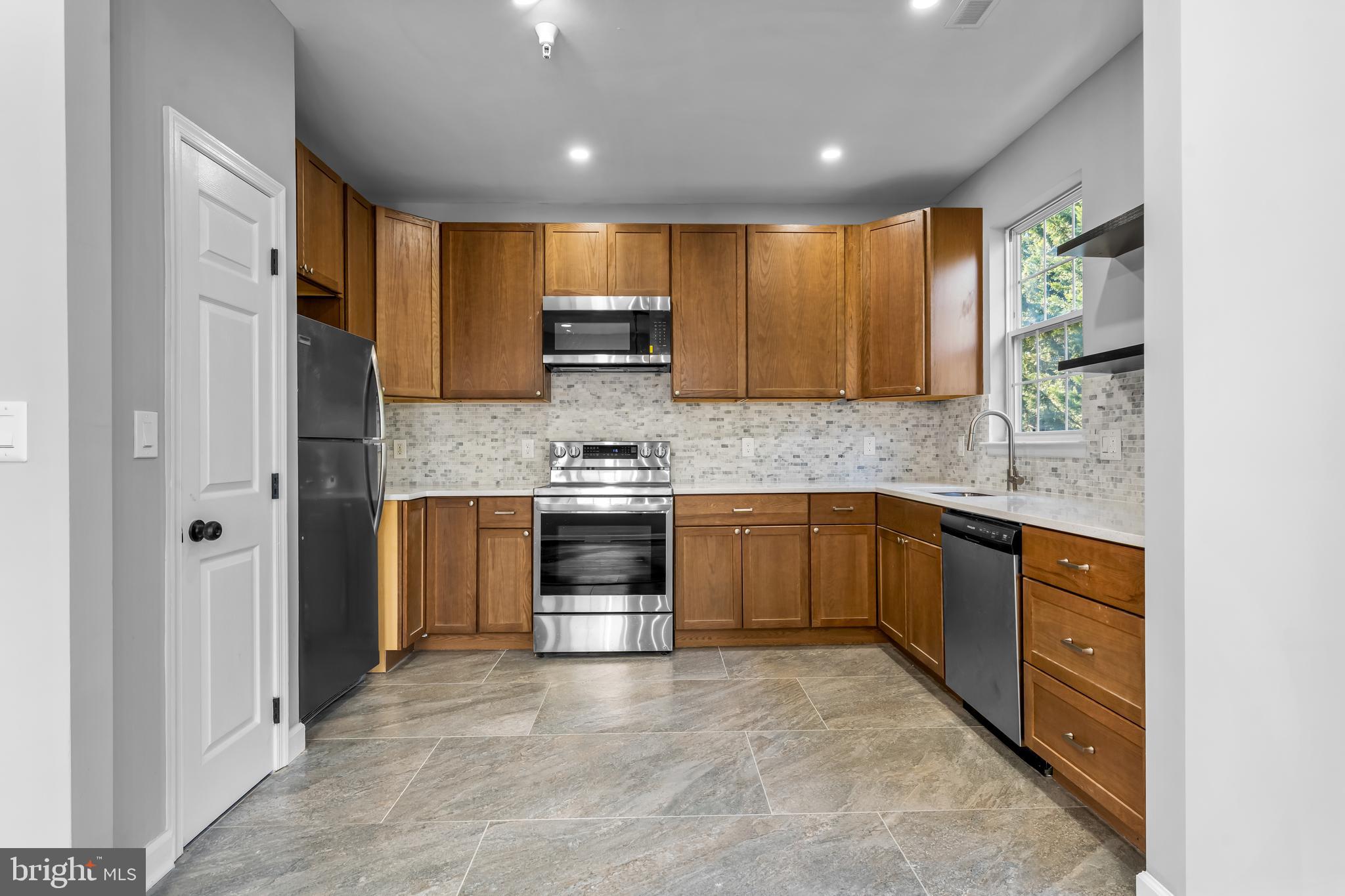 149 58th Street Southeast Washington, DC 20019 - Photo 18 of 32 a kitchen with stainless steel appliances granite countertop a refrigerator sink and stove