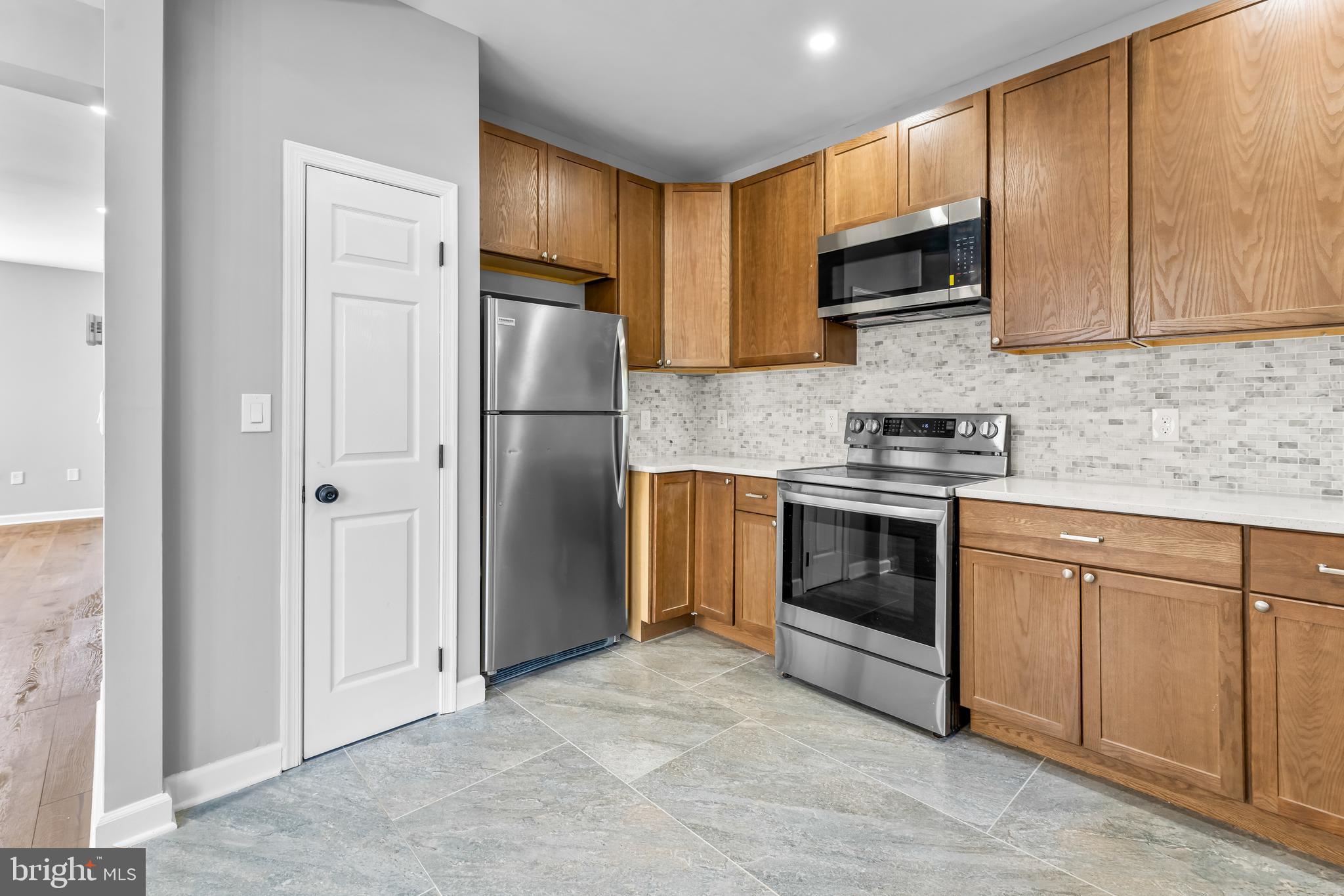 149 58th Street Southeast Washington, DC 20019 - Photo 20 of 32 a kitchen with stainless steel appliances granite countertop a refrigerator stove microwave and sink