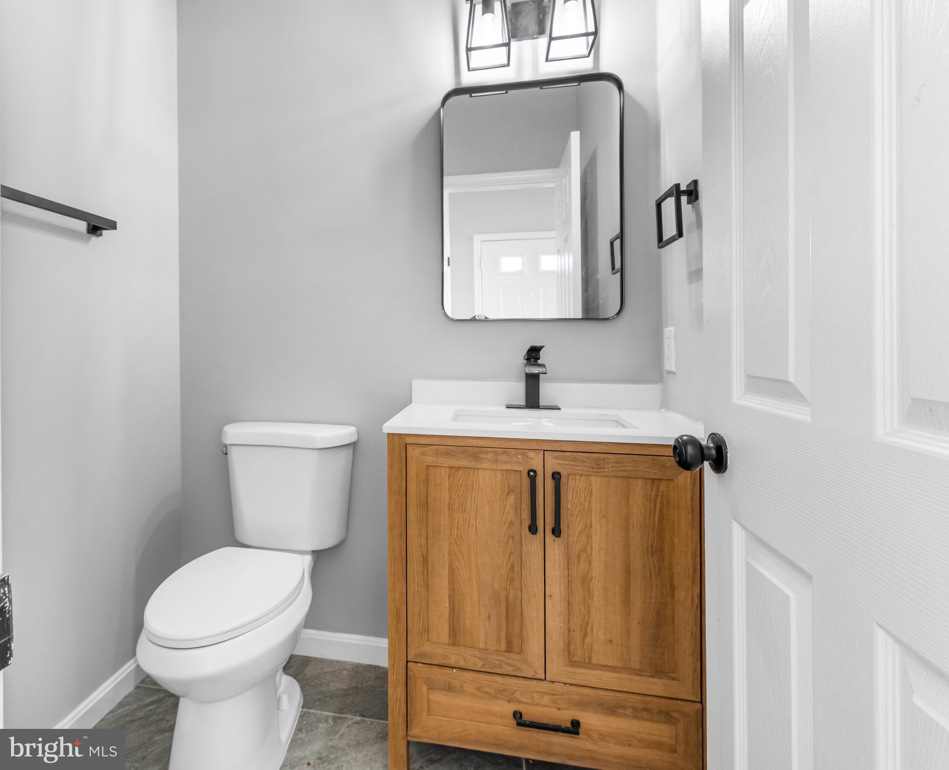 149 58th Street Southeast Washington, DC 20019 - Photo 27 of 32 a bathroom with a toilet sink and mirror