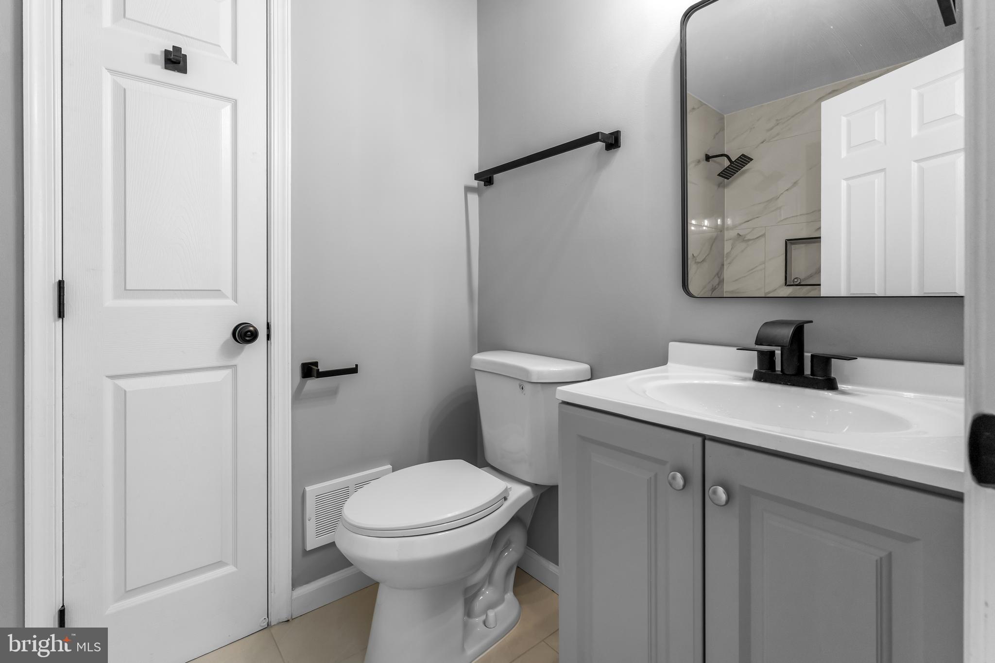 149 58th Street Southeast Washington, DC 20019 - Photo 28 of 32 a bathroom with a sink a toilet and shower