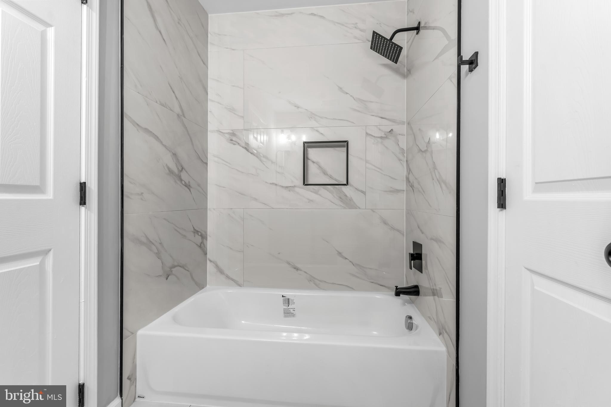 149 58th Street Southeast Washington, DC 20019 - Photo 29 of 32 a bathroom with a white bath tub a shower and a sink
