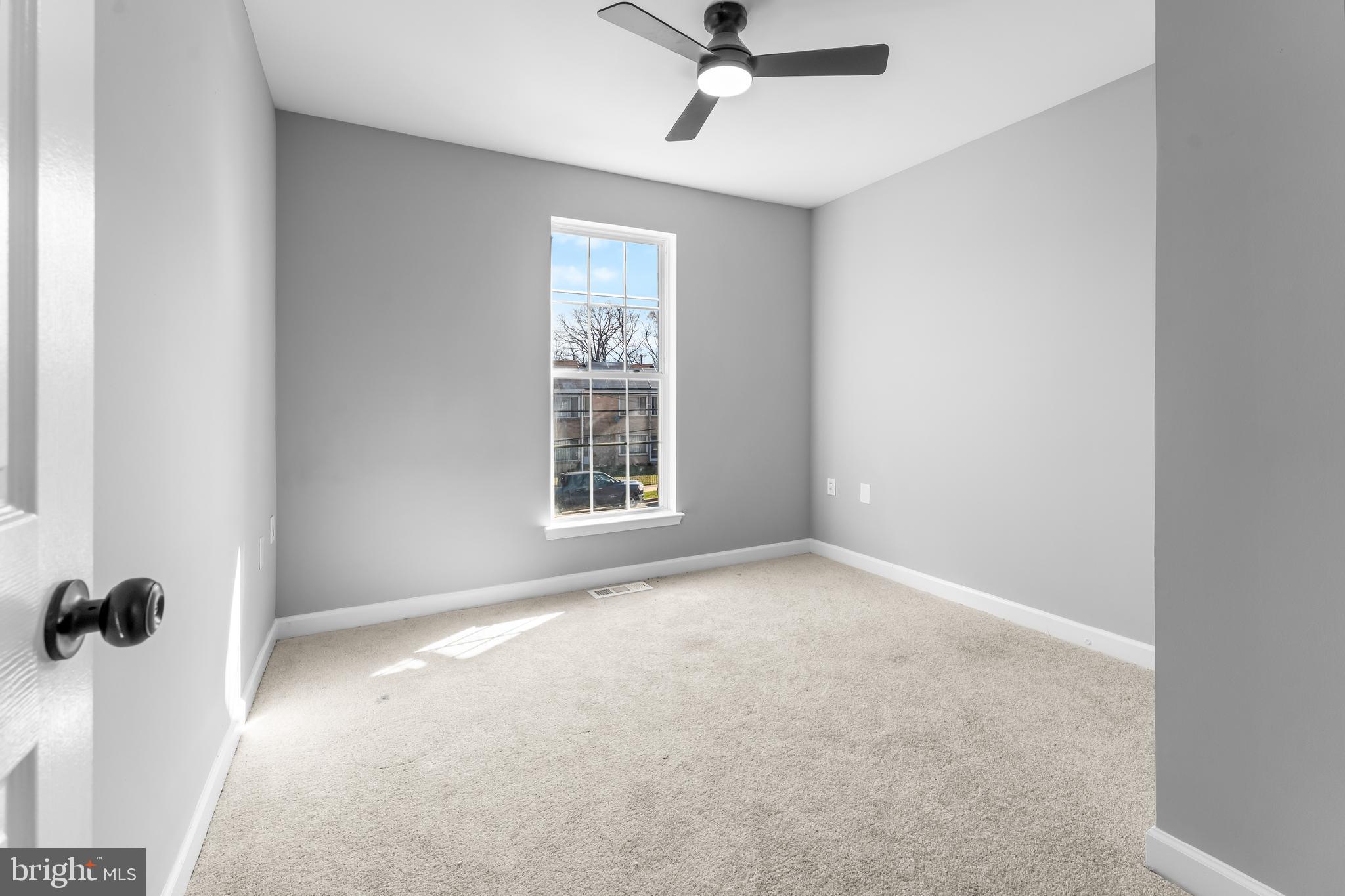 149 58th Street Southeast Washington, DC 20019 - Photo 9 of 32 an empty room with windows and fan