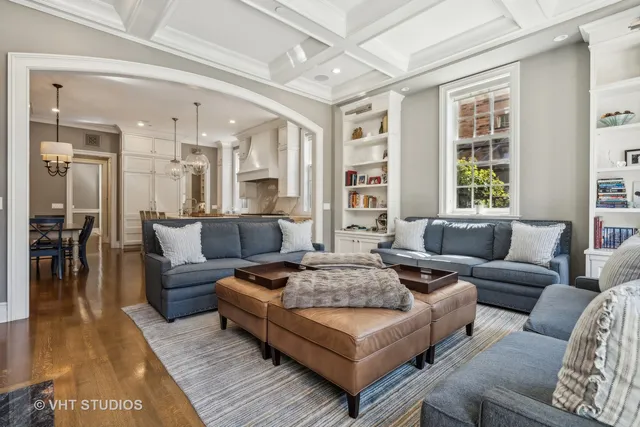 a view of staircase with lots of frames on wall and wooden floor