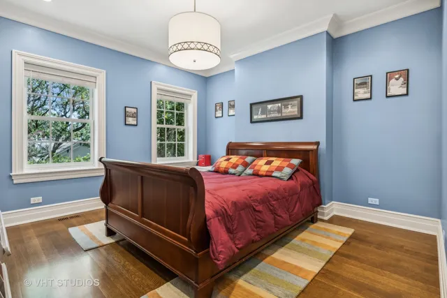 a bathroom with a sink a toilet a mirror and shower