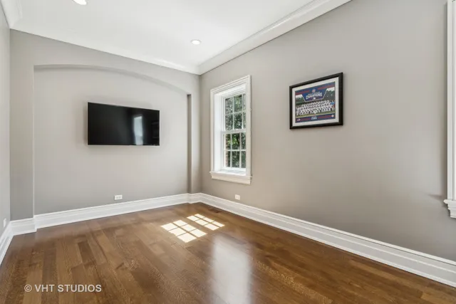 a bathroom with a stove and a wooden floor