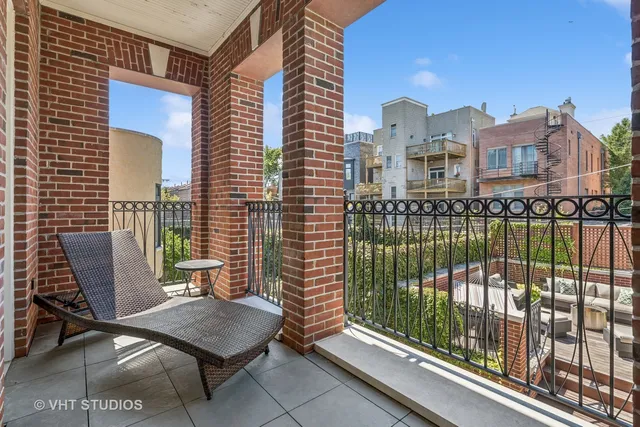 a view of a patio with couches chairs and wooden floor