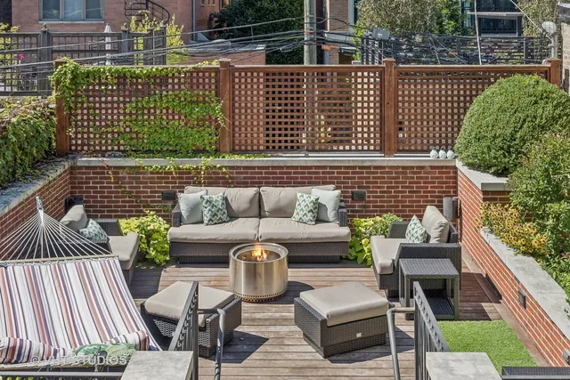 a view of a patio with couches chairs and wooden floor