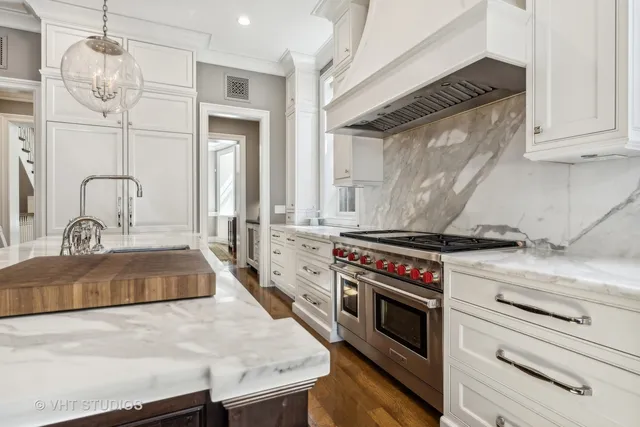 a view of a kitchen with granite countertop a sink and a stove