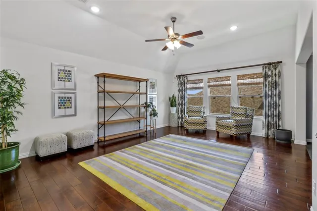 a bedroom with furniture and a wooden floor