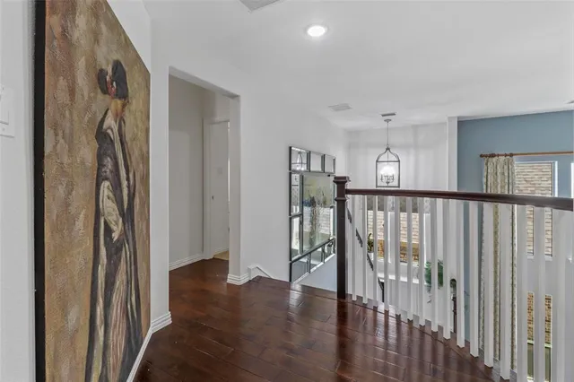 a view of a hallway with wooden floor and entryway