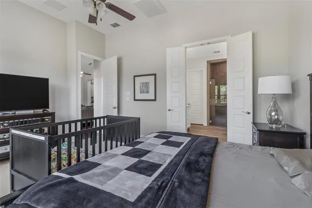 a bedroom with furniture and a flat screen tv
