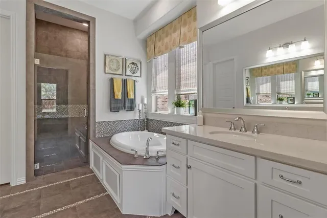 a bathroom with a tub sink and mirror