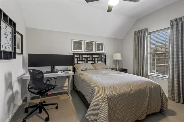 a bedroom with a bed and a desk