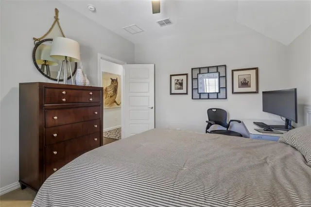 a bedroom with a bed and painting on the wall