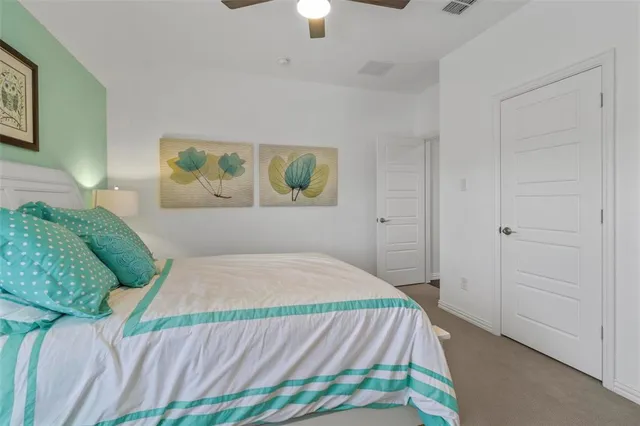 a bedroom with a bed and painting on the wall