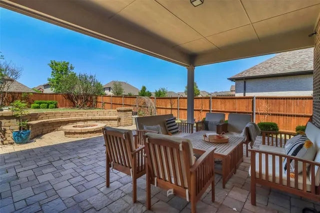 a view of a swimming pool and outdoor seating