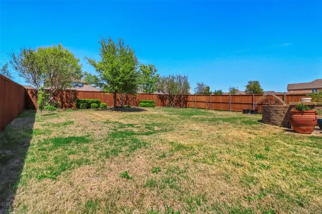 a front view of a house with yard and green space