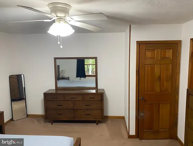 a living room with furniture and a mirror