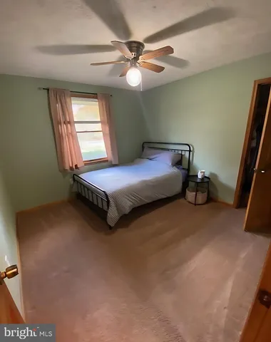 a bedroom with a bed and window