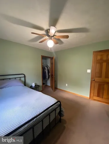 a bed room with a bed and a chandelier