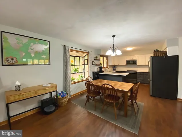 a room with table chairs and a window