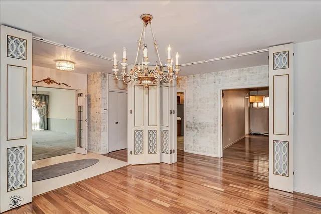 a view of a hallway with wooden floor