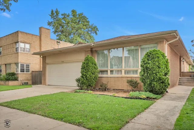 a front view of a house with a garden and plants