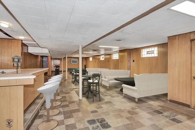 a living room with couches and kitchen view