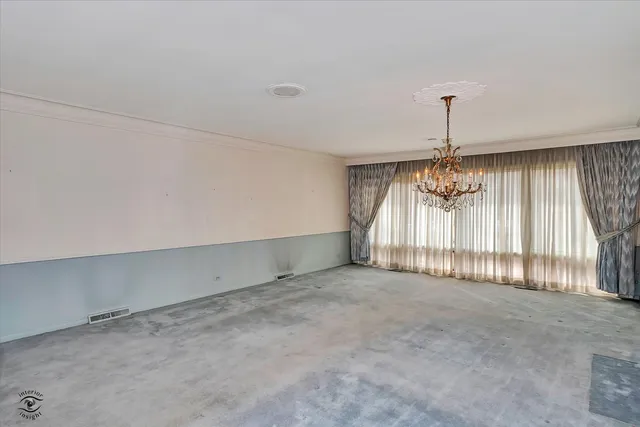 a view of an empty room and a window