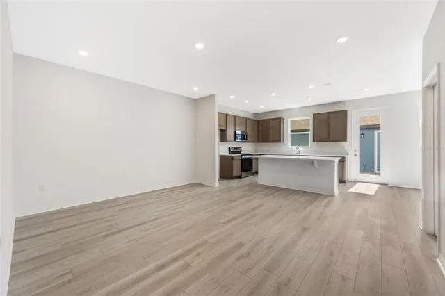 a view of a kitchen with a sink and white cabinets