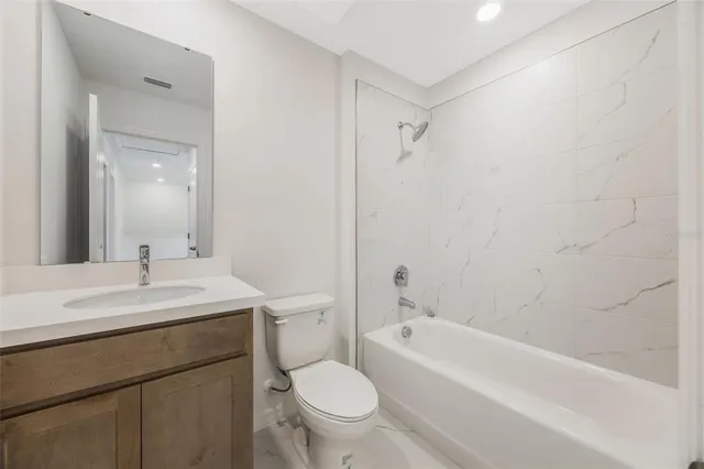 a bathroom with a sink a toilet and a bathtub