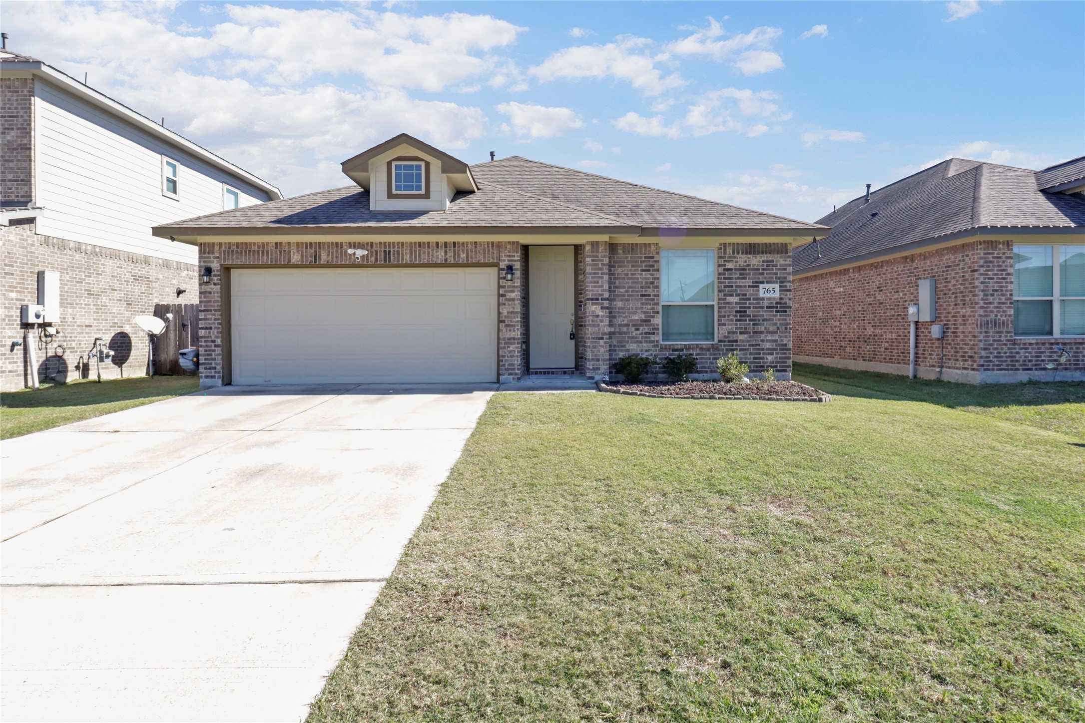 a front view of a house with a yard and garage