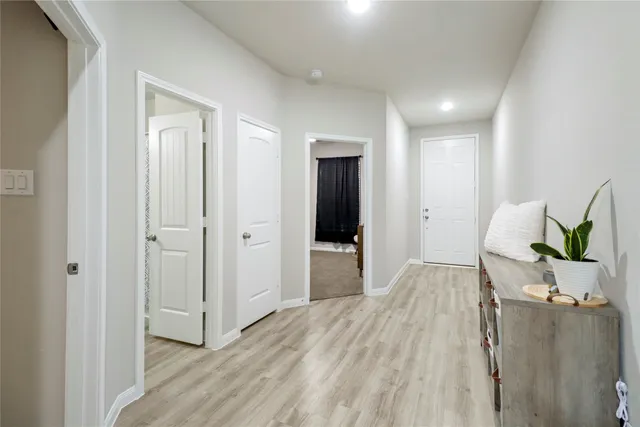a living room with a bed and a dresser