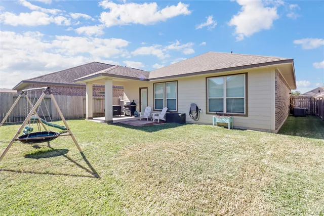 a view of a house with backyard and patio