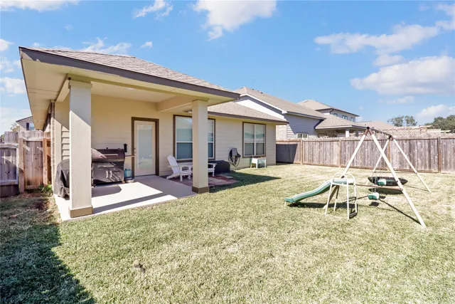 a view of a house with backyard porch and sitting area