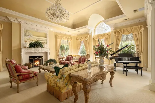 a view of a dining room with furniture and chandelier
